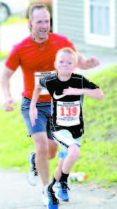 Matthew Kruse, age 8, and David Kruse push up the final hill.