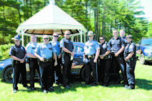 Fryeburg Police Officers left to right: David Arsenault, Andrew Jarman, Timothy Libby, Cody Belyea, Chief Joshua Potvin, Lt. Michael McAllister, Michelle Legare, Brandon Weckbacher, Harry Sims and Heidi Johnston. Fryeburg Police Domestic Violence Awareness Ribbons   Fryeburg Selectmen voted unanimously in late May to allow the placement of purple domestic violence awareness ribbons on the Police Departmentâ€™s cruisers and make them part of the permanent scheme.   The ribbons were requested by Chief Joshua Potvin to help officers spread domestic violence awareness while on patrol.   Fryeburg Police joined domestic violence advocates and supporters at Bradley Park on Main Street in Fryeburg last week for the unveiling of the ribbons. Lifelong resident and domestic violence survivor Donna Woodward placed the final ribbon on the cruiser at the ceremony.    â€œThe ribbons will be a great additional to our cruisers and I am pleased to have the selectmenâ€™s support in helping spread domestic violence awareness. The ribbons display our â€˜no excuseâ€™ approach to these types of crimes. It is our policy to ensure those affected by domestic violence receive the proper support they need and to hold their offenders accountable,â€ Chief Joshua Potvin said. The chief added, â€œOver half of the homicides in Maine were domestic violence related in 2014. Unfortunately, Fryeburg was not exempt from the chilling domestic violence homicide statistics and had the first domestic violence homicide for Maine in 2015.â€ The chief said domestic violence cases drain the departmentâ€™s resources and create a substantial safety risk to local officers.  â€œThese are crimes that not only affect those involved, but the community as a whole,â€ Chief Potvin said. â€œWe have reconstructed our response to domestic violence calls and have a mandatory arrest policy in place. With help from our partners at Family Crisis, Starting Point and Safe Voices, we conduct follow-up interviews with the victims within 48 hours of the incident to ensure he/she is receiving the help they need. Our officers are all trained in risk assessment to predict the likelihood of suspects re-offending.â€  The main purpose of displaying the domestic violence ribbons on FPD cruisers is to let the community know local police will support victims.   â€œWe equally wanted to send the message to offenders that there is no excuse and we will hold them accountable,â€ Chief Joshua Potvin said.    
