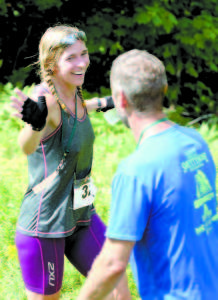 OFFERING SOME ENCOURAGEMENT as she begins her descent of Pleasant Mountain is Kelly Edwards of Raymond, the first woman overall. (Rivet Photo)