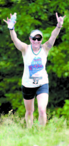 CONQUERING THE HILL â€” Jennifer Genovese of Windham celebrates as she reaches the summit. (Rivet Photo)
