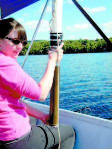 Kelsey Boeff UMaine Climate Change Institute holds a deep sediment core. (Photo by Colin Holme)