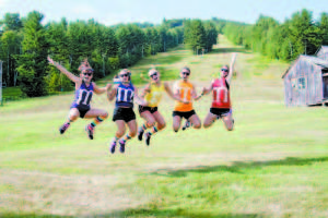 SPIRITED GROUP OF M&MS — As part of their summer festivities, friends Chace Conroy, Rosemarie Chandler, Julia Peet, Clare Conroy and Samantha Buckenmaier compete in the Great Adventure Challenge. They have taken part as a barbershop quintet with mustaches, raging princesses and this year as M&Ms. (Photo by Sheila Weeman)