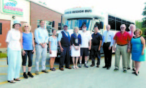 AMONG THOSE ON HAND to celebrate the start of bus service in Bridgton were, from left, Sally Chappell and another member of the Bridgton Transportation Coalition; Rick Harbison, planner for the Greater Portland Council of Governments; Carmen Lone, executive director of the Bridgton Community Center; Jack Uminski, Regional Transportation System bus driver; Phyllis Ginzler, state representative; Paul Hoyt, Bridgton selectman; Bill Hurley, transit supervisor for the Department of Transportation; Jack DeBeradinis, RTP executive director; Ken Murphy, Bridgton selectman; Bob Peabody, Bridgton town manager; and Anne Krieg, Bridgton planner.  (Geraghty Photo)  