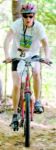 INTO THE FOREST is cyclist Kim Gluck of Newton, Mass. (Photo by Greg van Vliet/LakeRegionPhotography.com)