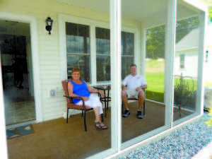 HOME IS WHERE THE HEART IS â€” With Main EcoHomes President Justin McIver, Barbara Gunville, formerly of Cohasset, Mass., says she especially loves the screened-in porch of her 640 square foot home at The Cottages at Willett Brook in Bridgton. Best of all, she says, is that now sheâ€™ll be living close to her four children and their families in Maine.  3 JUSTIN AND BARBARA stand in front of her new home, showing the solar panels on the roof that will reduce her utility costs to close to net zero.  