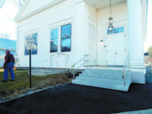 NEW STEPS AND RAILING have been built at the entrance to Town Hall. The enclosure at left has also been removed. 