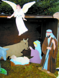 The kneeling mother Mary and baby Jesus in the manger, which was donated to the Casco Village Church to replace the two figures that were stolen, blend harmoniously with the other figures and have a meaningful history. (De Busk Photo)