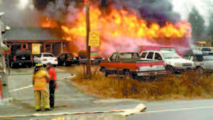 ENGULFED â€” Fire ripped through the Ovide Used Cars dealership on Christmas Eve. (Photo courtesy of WCSH)