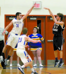 BEN DARLING of Fryeburg Academy knocks down a three-point shot during the first quarter, despite a block attempt by Laker Nate Smith. (Rivet Photos)