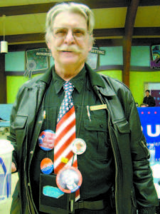  DENNIS DEMPSEY, of Gray, sports several political pins at the Republican caucus on Saturday. â€œI am here to show support, volunteer my service and to get a big yard sign,â€ Dempsey said. (De Busk Photo) Bridgton Democratic Committee caucus results Bernie Sanders: Seven delegates to attend Maine Democratic Convention  Hillary Clinton: Four delegates to attend Maine Democratic Convention     By Dawn De Busk Staff Writer So many Bridgton residents showed up to participate in the Democratic caucus that it became apparent some fresh air needed to circulate through the packed room, according to Caucus Convener Linda England.  â€œWe were jammed in the room. There was so much body heat in one room that we had to open the windows,â€ England said. Bernie Sanders was the hot ticket during Maineâ€™s caucuses â€” garnering about two-thirds of the votes, compared to Hillary Clinton.  â€œBernie Sanders absolutely overwhelmingly won,â€ England said.  The Bridgton caucus resulted in giving seven delegates to Sanders, while Clinton received four delegates. Those people will go to the Maine Democratic Convention in Portland this spring.  As was the case statewide, the local Democratic caucus experienced an impressive turnout.  â€œIt was the largest turnout that Bridgton ever had,â€ said England, who served as chairman of the Bridgton Democratic Committee until local posts changed over at Sundayâ€™s caucus.  Bridgtonâ€™s Democratic caucus kicked off at 1 p.m. in the downstairs meeting room of the Municipal Complex. It took more than an hour â€” with volunteers working full-steam â€” to register everyone who was eligible to participate in the caucus, she said. Registration took a long time regionwide. With absentee votes included, the total number of people was slightly less than 200.   Big turnouts and long waits arenâ€™t all bad news.  â€œIt takes so long when you have this much enthusiasm,â€ England said.   The turnout represented people from all walks of life and a wide spectrum of ages.  â€œIt was a meeting of families: single parents, married parents, and aging parents. We had people in wheelchairs and people using walkers. We had people who are going to vote for the first time in November â€” with a spark in their eyes and enthusiasm to take part in the process of a democratic republic,â€ she said. England summarized the comments of speakers who favored Sanders.  â€œPeople said that he understands the needs of our country, of the average citizen. Itâ€™s all about meeting the needs of an entire population in all areas,â€ she said, listing health care, creating more jobs, keeping businesses from relocating to other countries because of better tax breaks as some of the issues people mentioned.  When people spoke about Sanders, they said â€œhe has never wavered in his desire to meet the needs of the people, or of the country. He has never been available for sale,â€ she said. â€œExtraordinary ethics or having integrity is something else I heard a lotâ€ about Sanders, she said. 