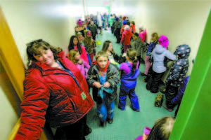 CHOKE POINT â€” All traffic coming and going to the playground at Songo Locks School must flow through a single-wide doorway, which becomes a choke point during recess transitions.