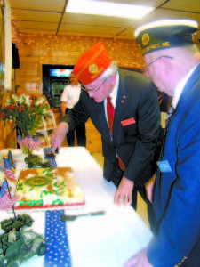 POST 155 VISITED â€” Dale Barnett, the 2015â€“16 National Commander of the American Legion, stands outside the American Legion Post 155 in Naples on Saturday. Members of the Legion treated Barnett and attendees to a multi-course meal during the banquet. (De Busk Photo) COMMANDER CUTS CAKE â€” National Commander Dale Barnett cuts a patriotic cake during the banquet at the American Legion Post 155. (De Busk Photo)