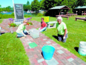 A BEAUTIFUL MEMORIAL â€” The Raymond-based volunteer group that participates in the weekly â€˜Walk and Weedâ€™ work installed the bricks along with planting flowers at the Raymond Veteransâ€™ Memorial Park in 2013. This Friday, the group plans to spruce up the park, pulling out tulips and planting red, white and blue flowers. (Photo courtesy of Raymond Beautification Committee)    