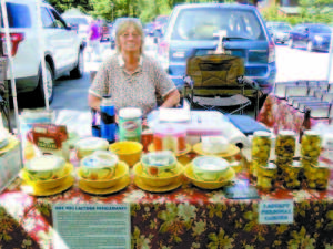 A MATTER OF SUPPLY AND DEMAND â€” Helen Ramsdell, shown here selling her goat cheese at last summerâ€™s Bridgton Farmersâ€™ Market, said most people donâ€™t realize that a farmersâ€™ market with multiple vendors is a business, and as such follows the law of supply and demand. Only so many people will buy a specialty item like goat cheese on any given Saturday, so it doesnâ€™t make sense for more than one vendor to offer the cheese. â€œI couldnâ€™t survive without selling cheese,â€ said Ramsdell, who raises Nubian dairy goats at Rams Farm in Denmark with A. Victoria Drew. 