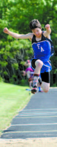 ALFIE WALKER competes in the triple jump.