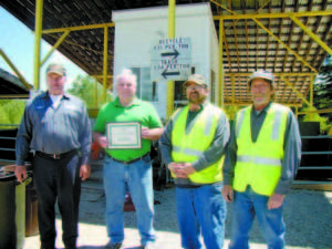 PROUD OF AWARD â€” Brownfield Public Works Director Frank Day, Brownfield Selectman Bill Flynn, and transfer station employees Joe Vaughn and Richard Welch pose with the 2016 Most Improved Transfer Station Award. (De Busk Photo)