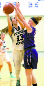 Senior guard Mackenzie Buzzell takes the ball strong to the basket, drawing a foul.